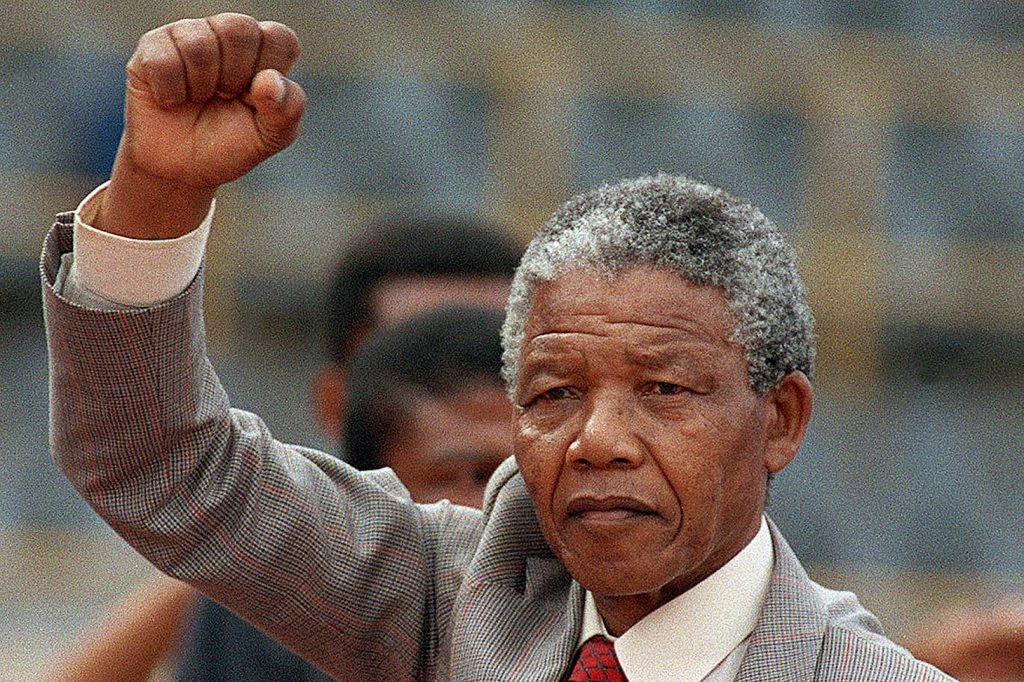 Anti-apartheid leader and African National Congress (ANC) member Nelson Mandela raises clenched fist, arriving to address mass rally, a few days after his release from jail, 25 February 1990, in the conservative Afrikaaner town of Bloemfontein, where ANC was formed 75 years ago.        (Photo credit should read TREVOR SAMSON/AFP/Getty Images)